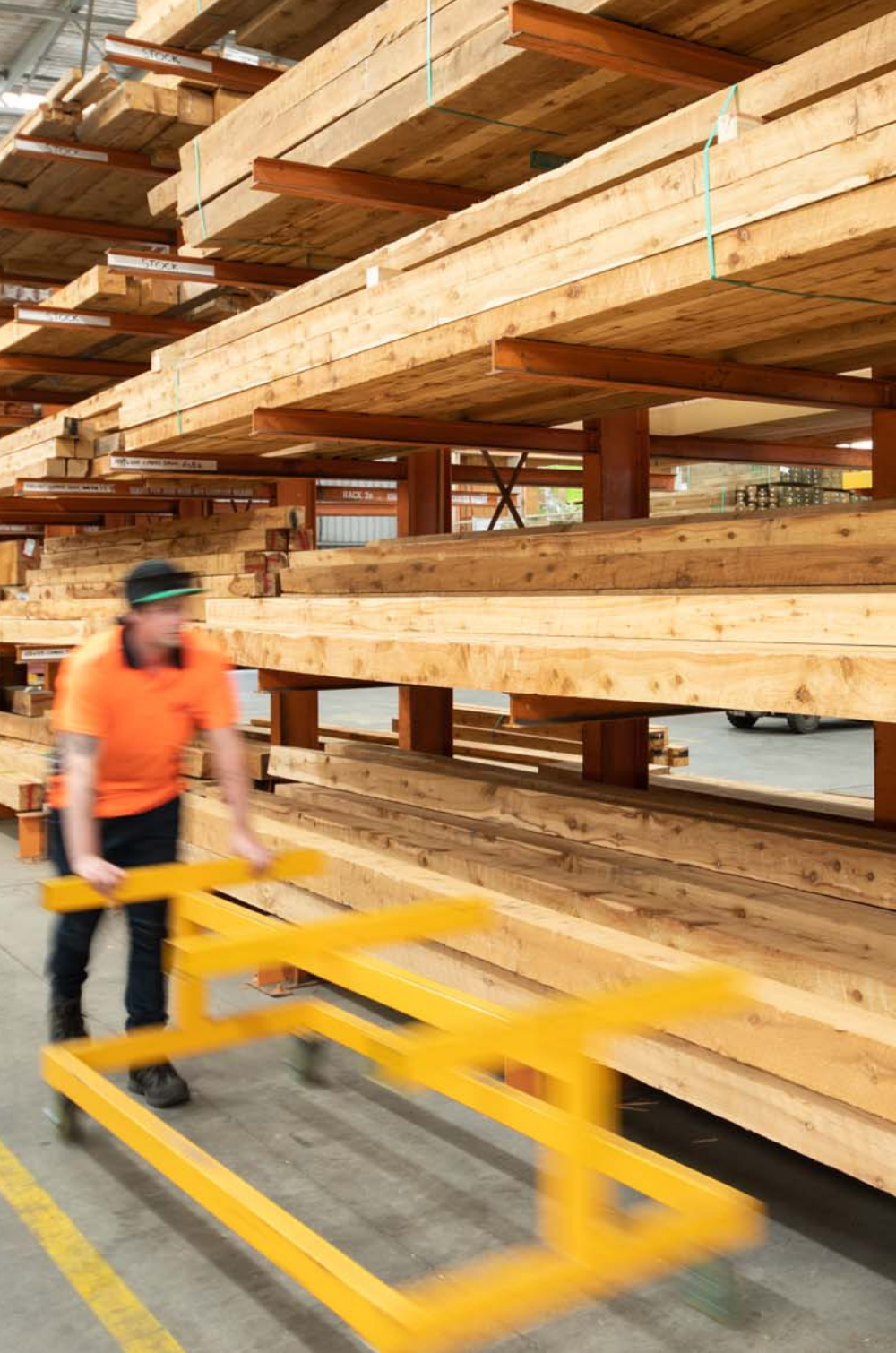 staff member pushing machine with timber in background